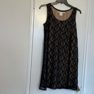 Very elegant & versatile little black dress.  Black lace with beige lining.
